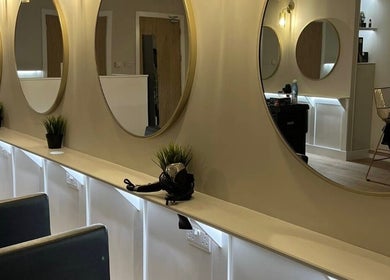 Chic salon interior at Alex @ Jazmine Love hair in Carmarthen, Wales, GB with elegant mirrors and seating.