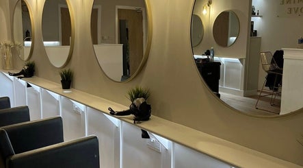 Chic salon interior at Alex @ Jazmine Love hair in Carmarthen, Wales, GB with elegant mirrors and seating.