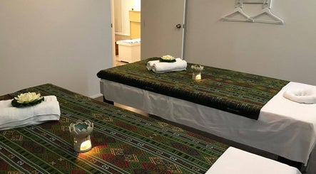 Relaxing massage room at Remedy Thai Massage and Spa in Auckland, NZ, with calm ambiance and traditional decor.