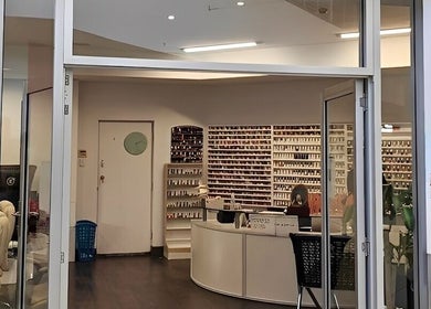 Entrance of Findon Nails and Spa Findon Shopping Centre (COLES) in Findon, South Australia, AU, showcasing nail polish displays.