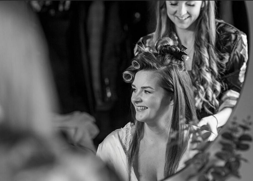 Stylist at Hair by Tamiyya in Reading, England, GB, creating a joyful salon experience with happy client.