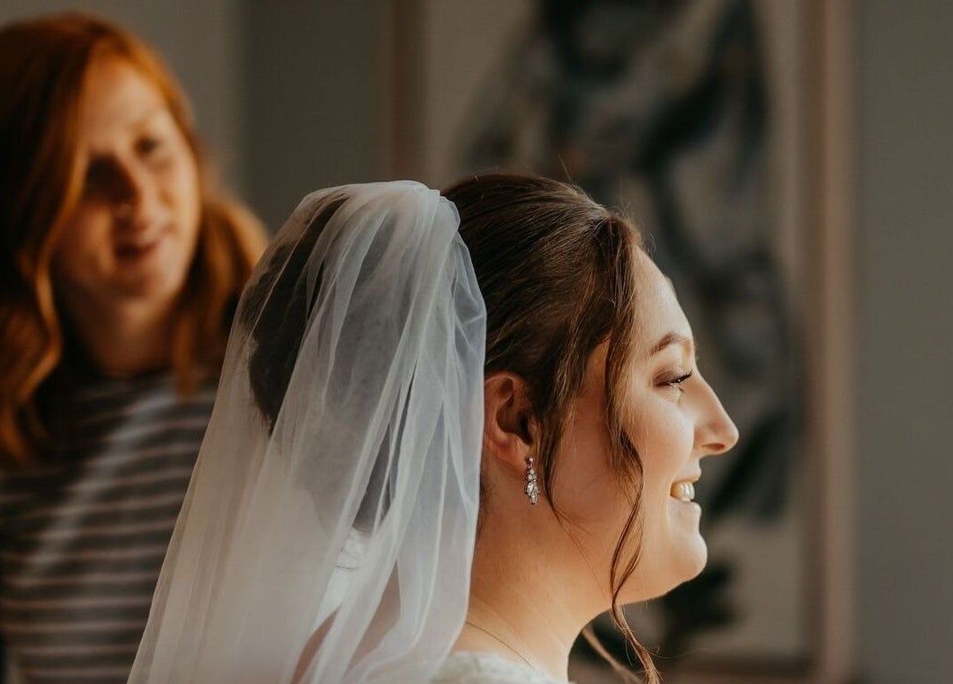 Stylist perfecting bride's hair at Hair by Tamiyya, Reading, England, GB.