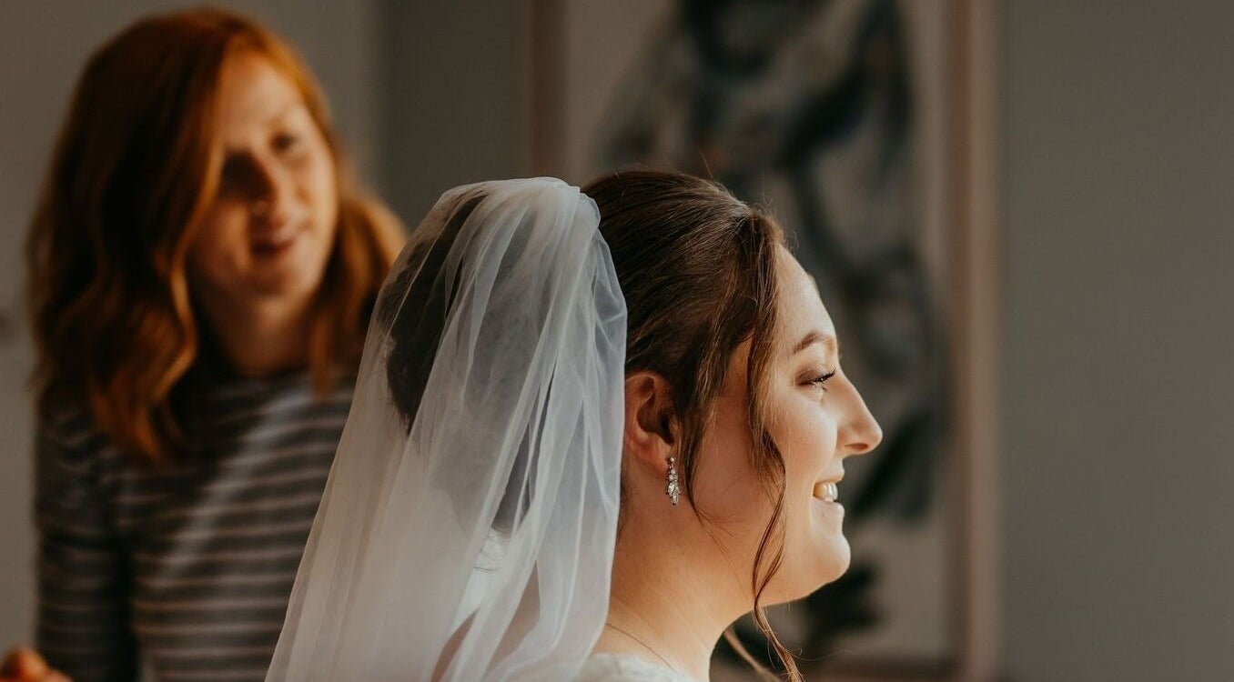 Stylist perfecting bride's hair at Hair by Tamiyya, Reading, England, GB.