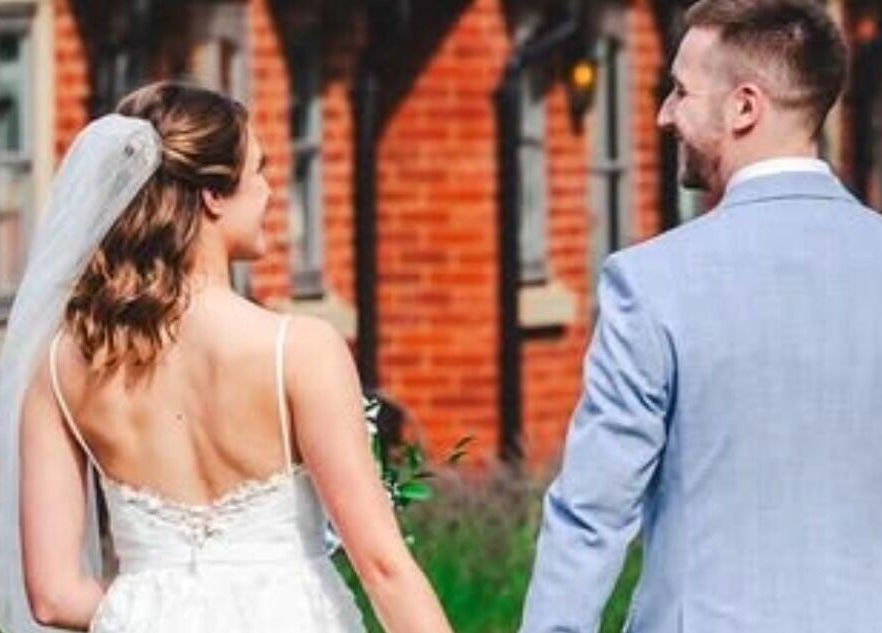Bride and groom outside Hair by Tamiyya, Reading, England, GB, showcasing elegant bridal beauty.