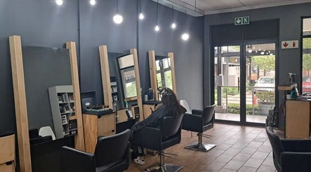 Elegant hair salon interior at Manetain, Pretoria, Gauteng, ZA, showcasing stylish chairs and mirrors.