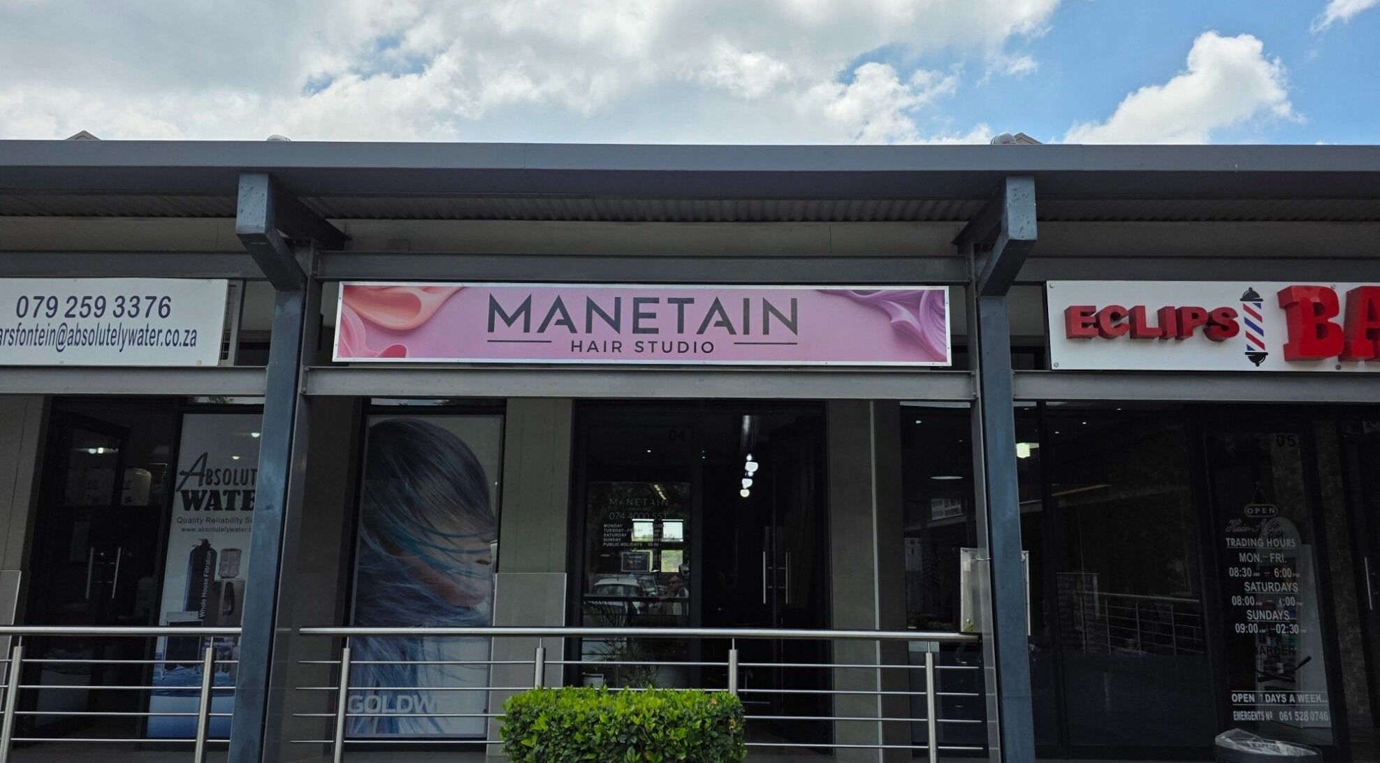 Exterior of Manetain Hair Studio in Pretoria, Gauteng, ZA with stylish signage.