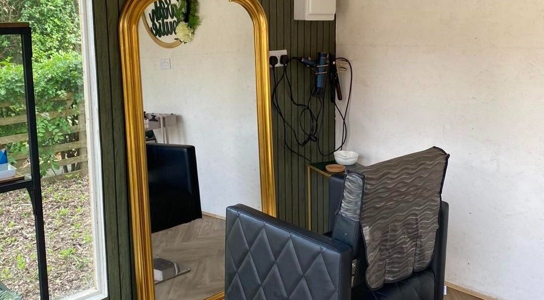 Elegant hair styling chair with large gold-framed mirror at Hair by Sarah Louise, Pickering, England, GB.