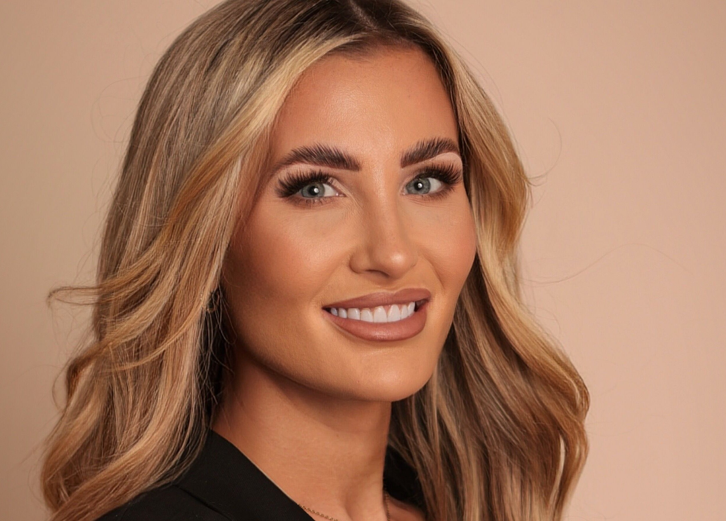 Smiling woman with styled blonde hair captured at LIV Aesthetics - Brow and Co Shipley, Shipley, England, GB.