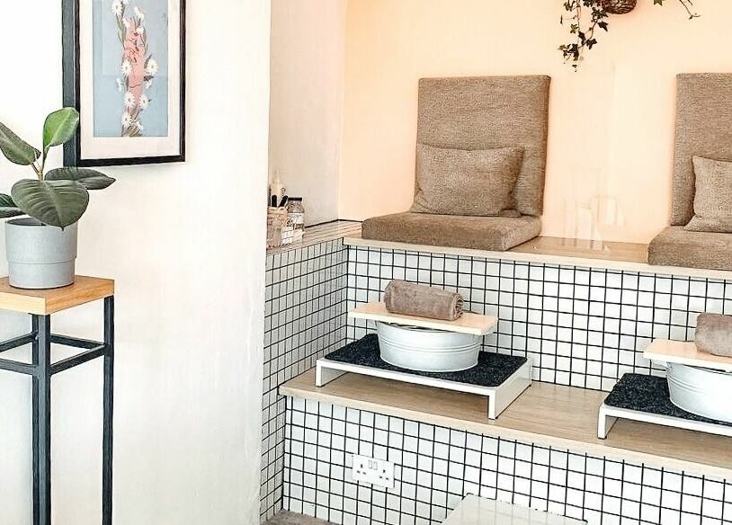 Elegant pedicure station at Un|Basic, London, England, GB showcasing plush seating and modern decor.