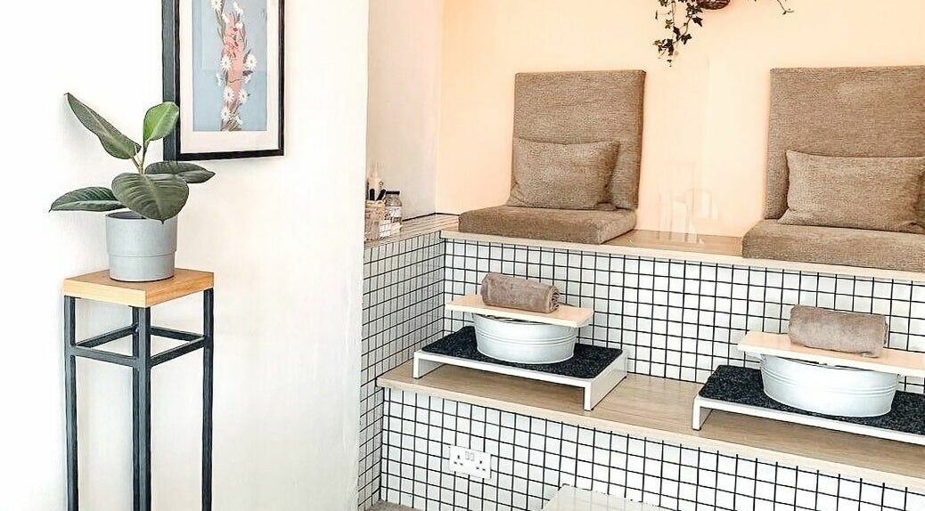 Elegant pedicure station at Un|Basic, London, England, GB showcasing plush seating and modern decor.