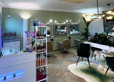 Interno elegante di ID Parrucchieri a Capannoli, Toscana, IT con arredi moderni e piante verdi.