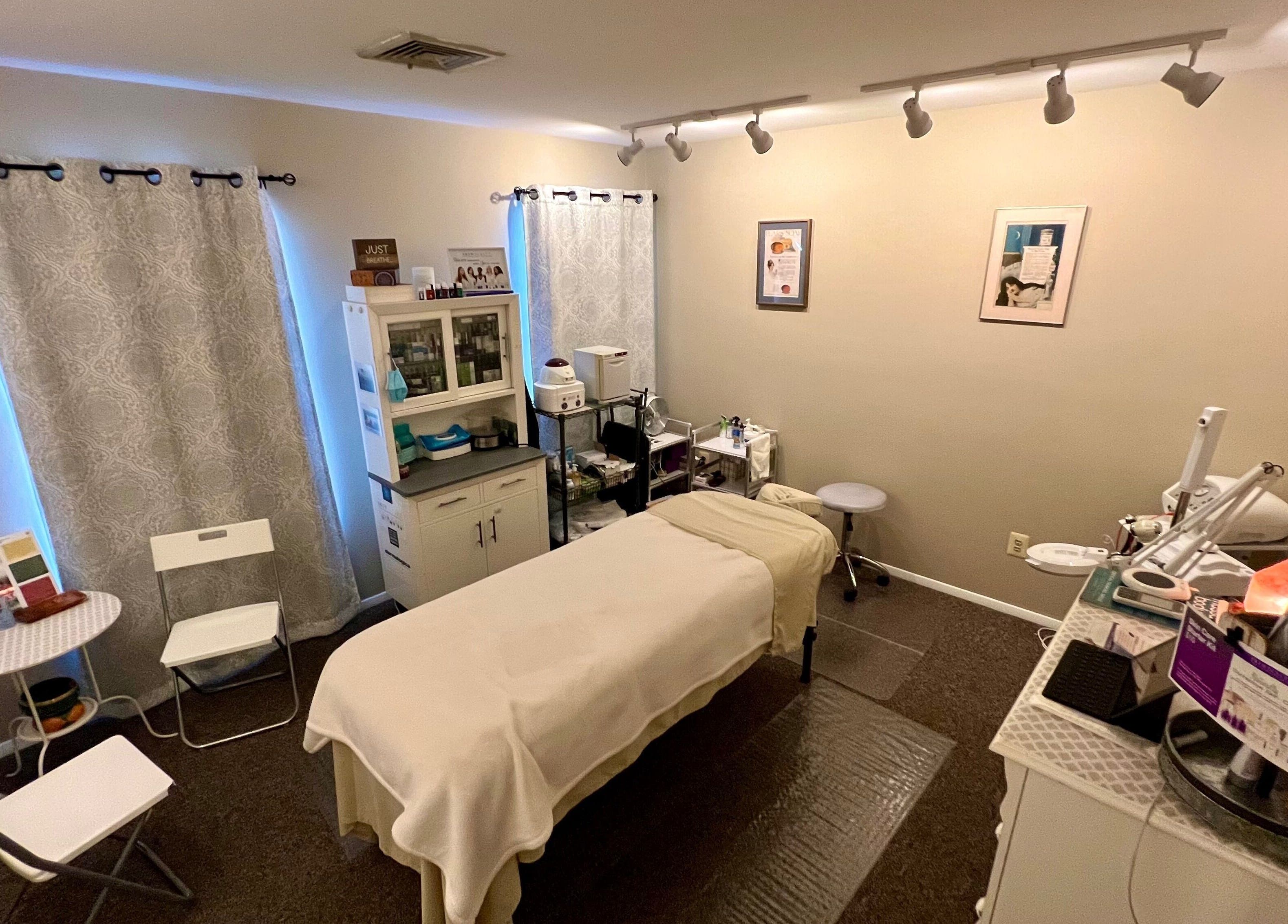Earth Beauty Essentials, LLC in Flemington, New Jersey, US: serene spa room with massage table and essential oils.