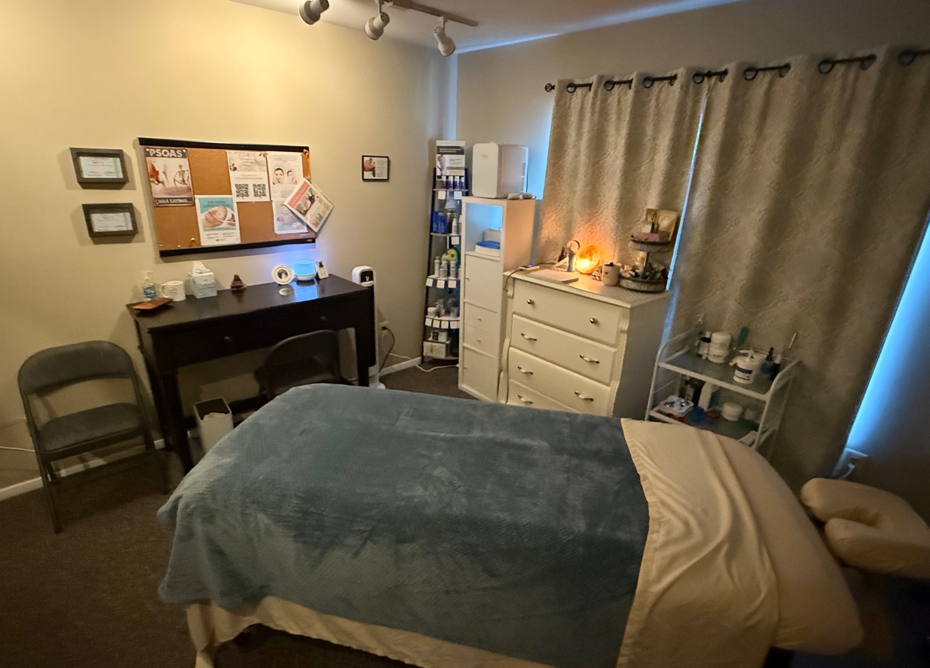 Cozy massage room at Earth Beauty Essentials, LLC in Flemington, New Jersey, US, featuring a treatment bed and ambient lighting.