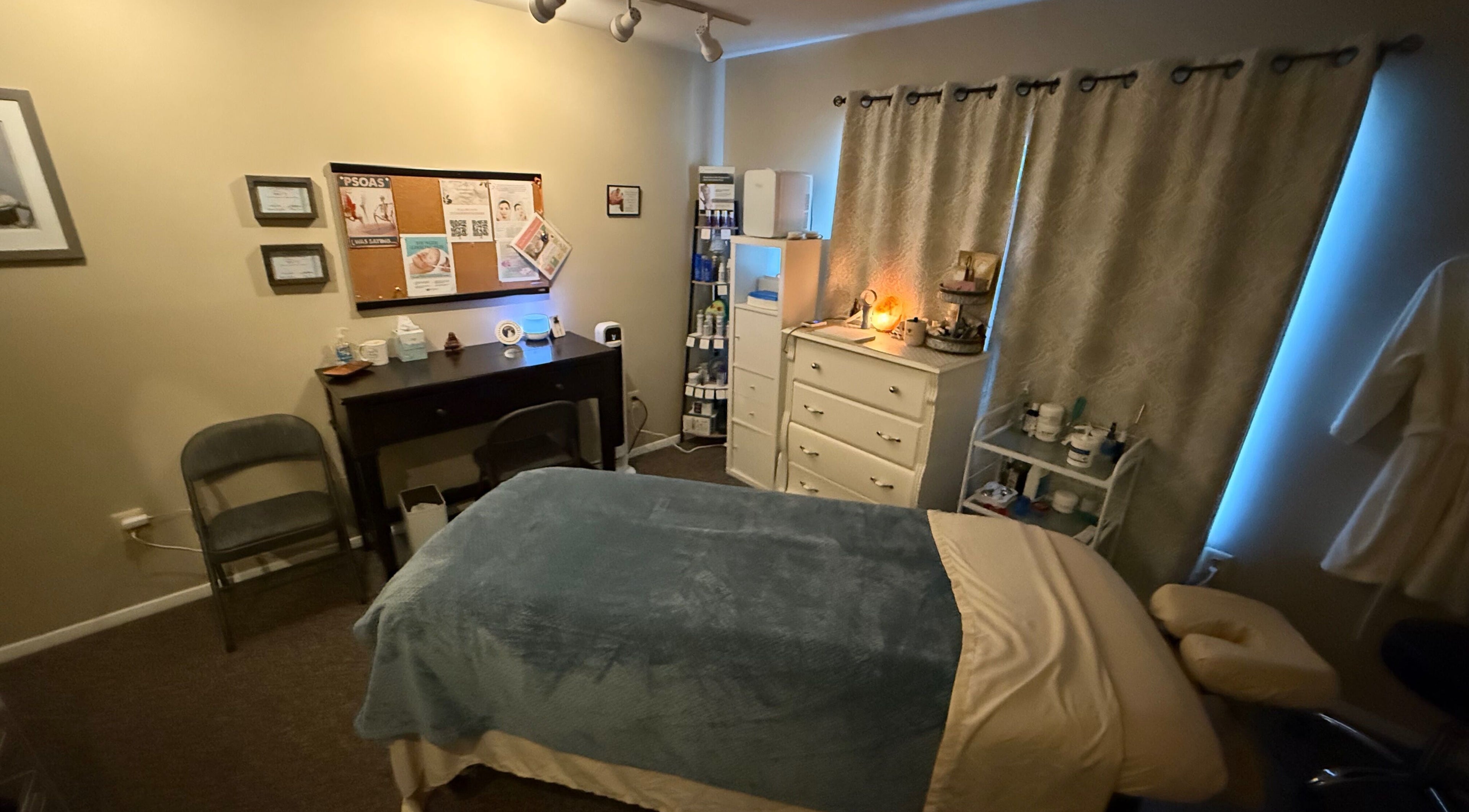 Cozy massage room at Earth Beauty Essentials, LLC in Flemington, New Jersey, US, featuring a treatment bed and ambient lighting.