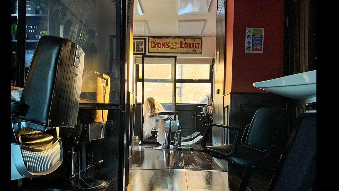 Cozy interior of John at Mulholland Barbering in Portadown, Northern Ireland, GB featuring vintage decor.