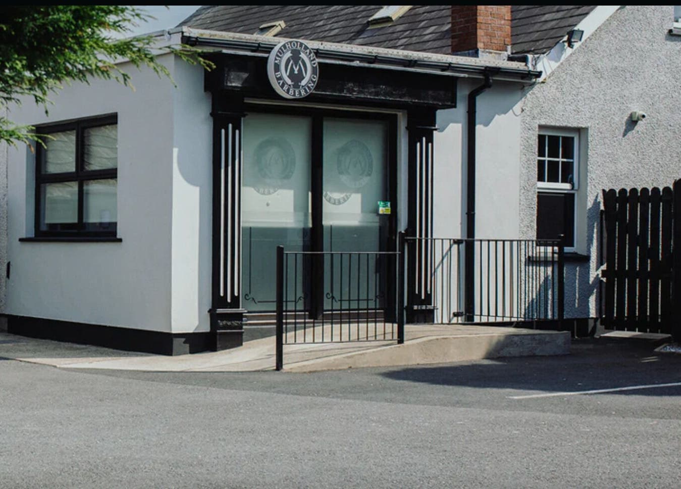 Front entrance of John at Mulholland Barbering, Portadown, Northern Ireland, GB, showcasing modern design.
