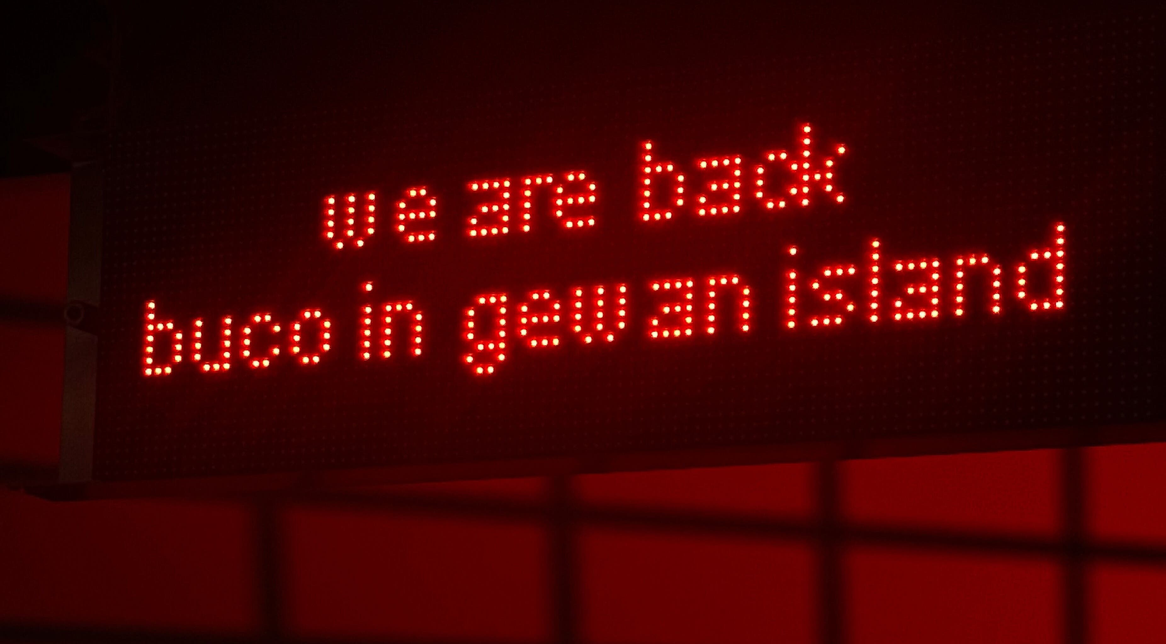LED sign at Buco Piercing Parlor, Doha, Doha, QA, displaying 'we are back buco in gewan island'.