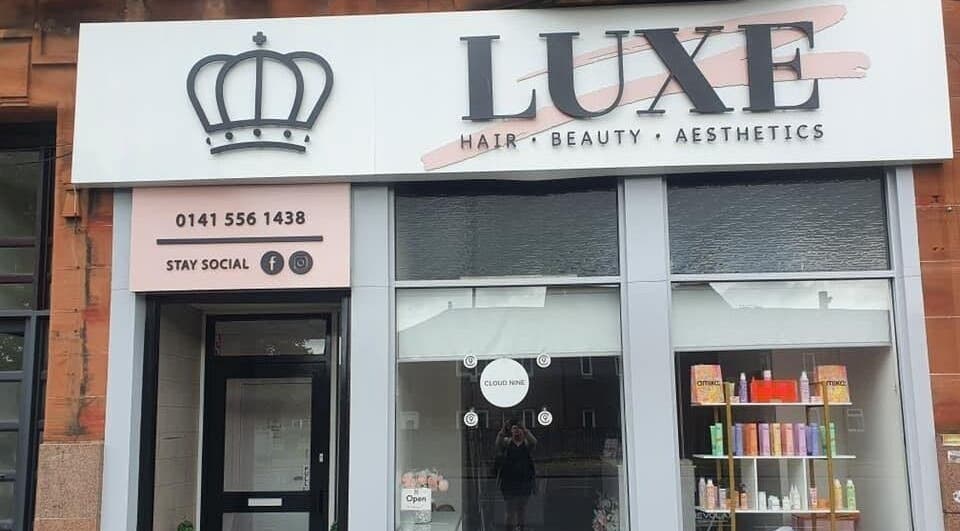 Front view of Luxe Hair Beauty Aesthetics in Glasgow, Scotland, GB showcasing stylish window displays.