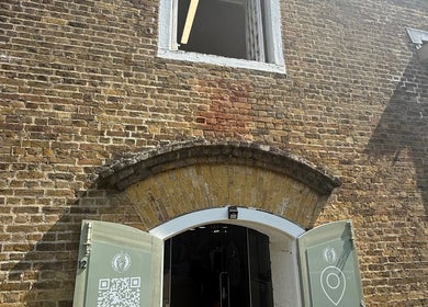 Entrance to No Bad Days in Rochester, England, GB features brickwork and archway.