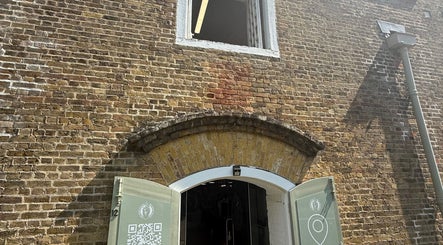 Entrance to No Bad Days in Rochester, England, GB features brickwork and archway.