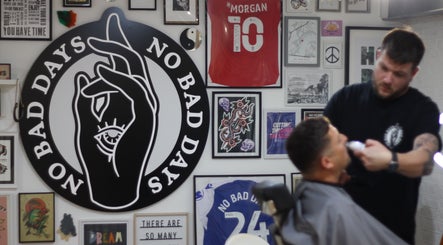 Barber styling client at No Bad Days, Rochester, England, GB, surrounded by unique art and decor.