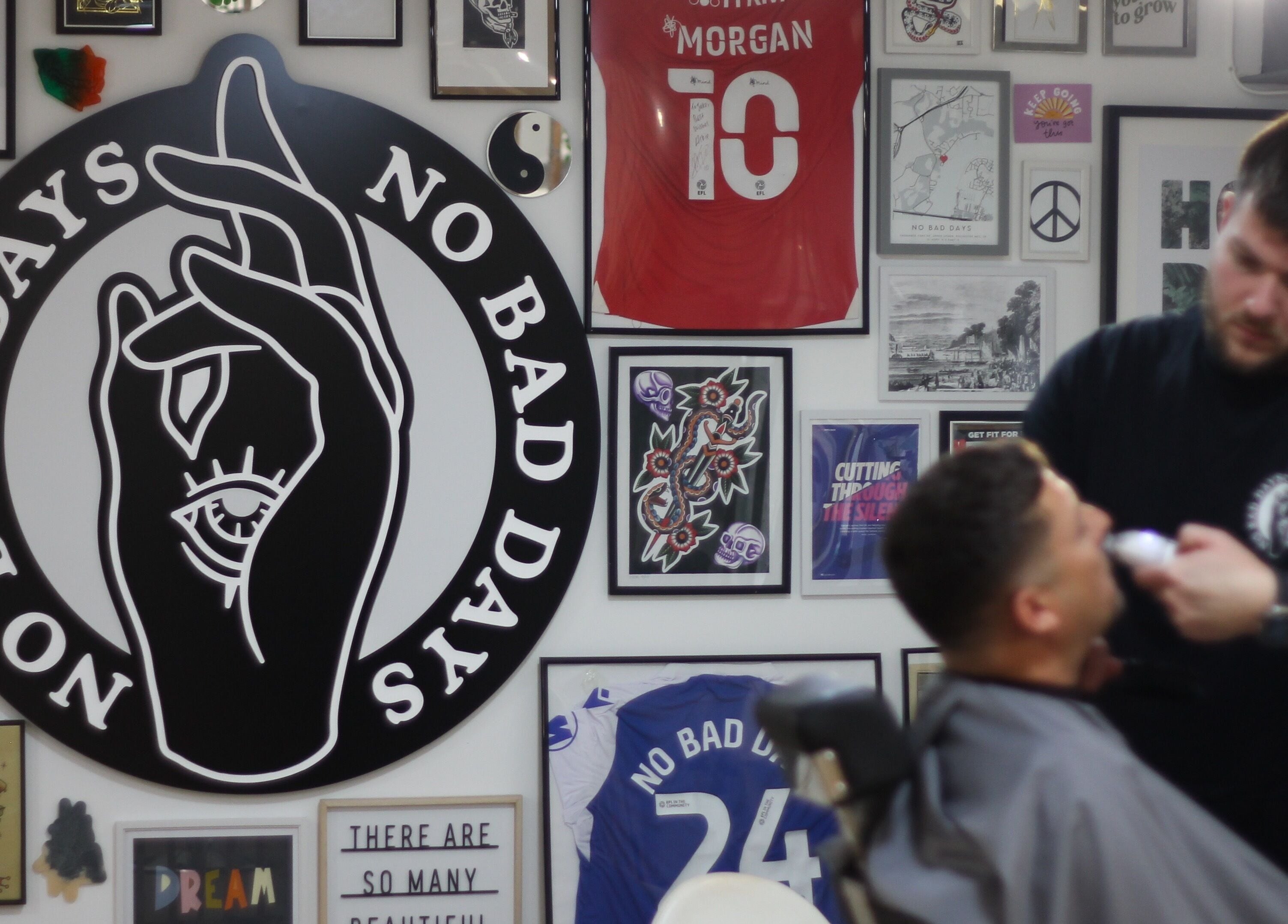 Haircut in progress at No Bad Days, Rochester, England. Vibrant decor with unique art pieces.