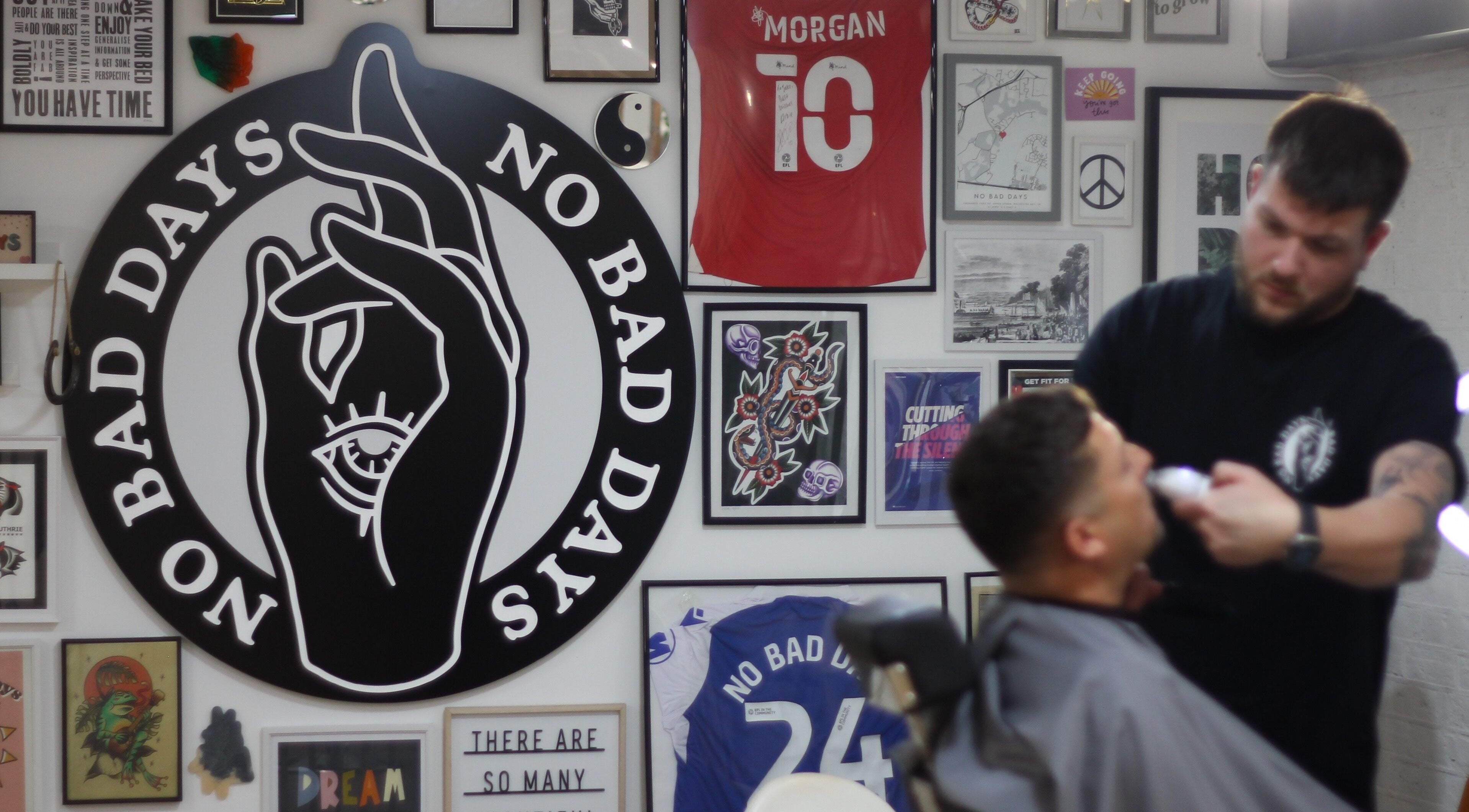 Haircut in progress at No Bad Days, Rochester, England. Vibrant decor with unique art pieces.