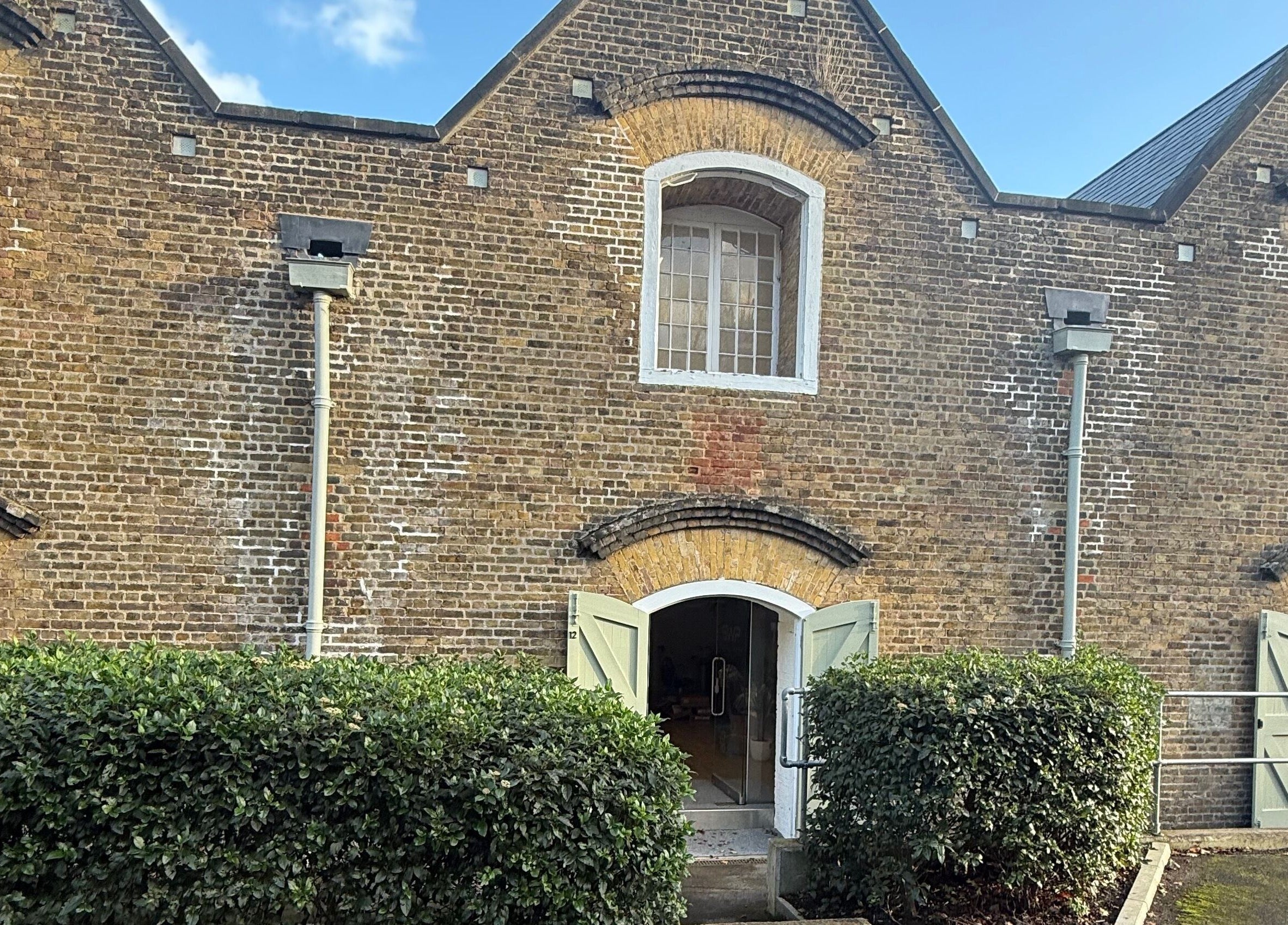 No Bad Days in Rochester, England, GB showcasing a rustic brick exterior and arched doors.
