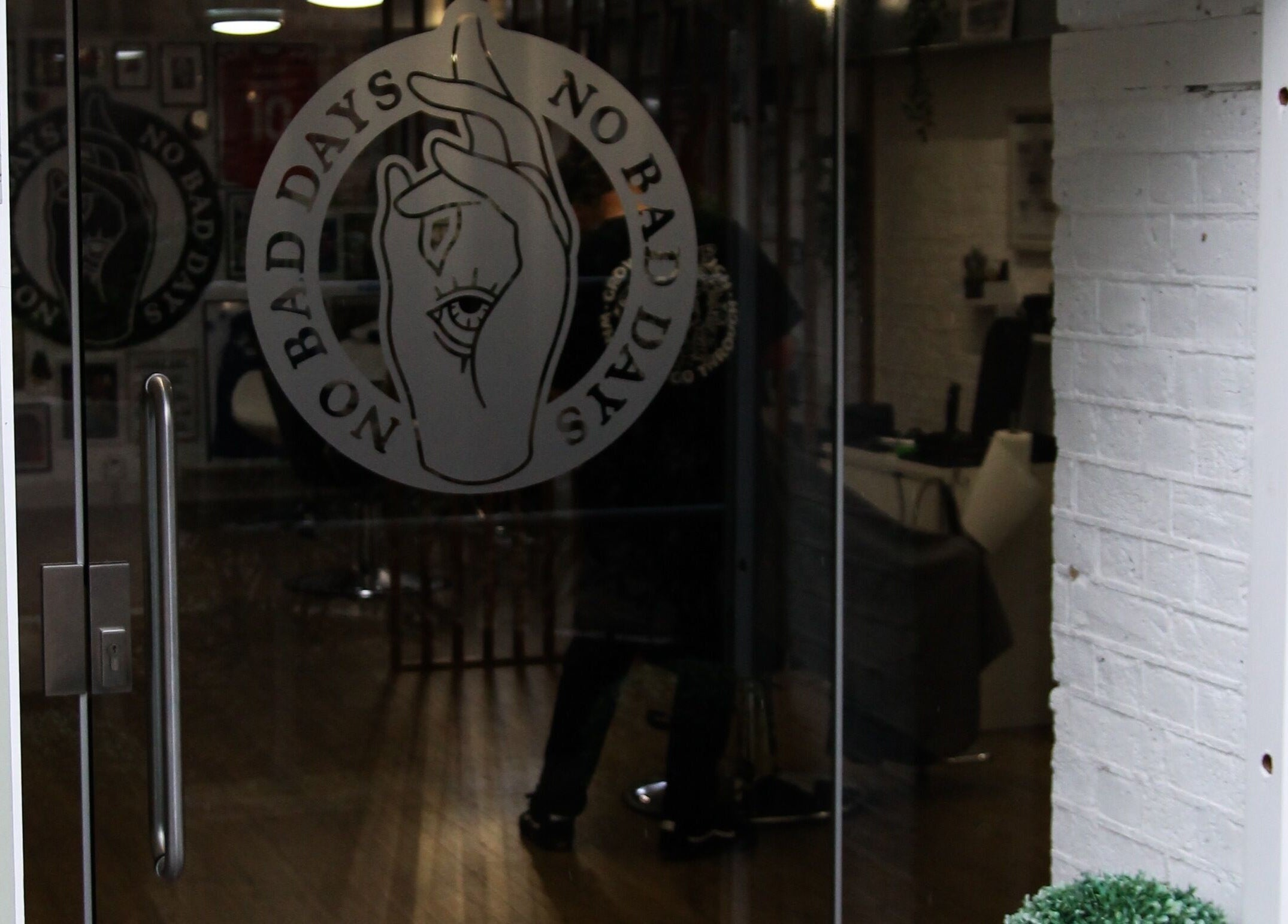 Entrance of No Bad Days salon in Rochester, England, GB, featuring elegant glass door with logo.