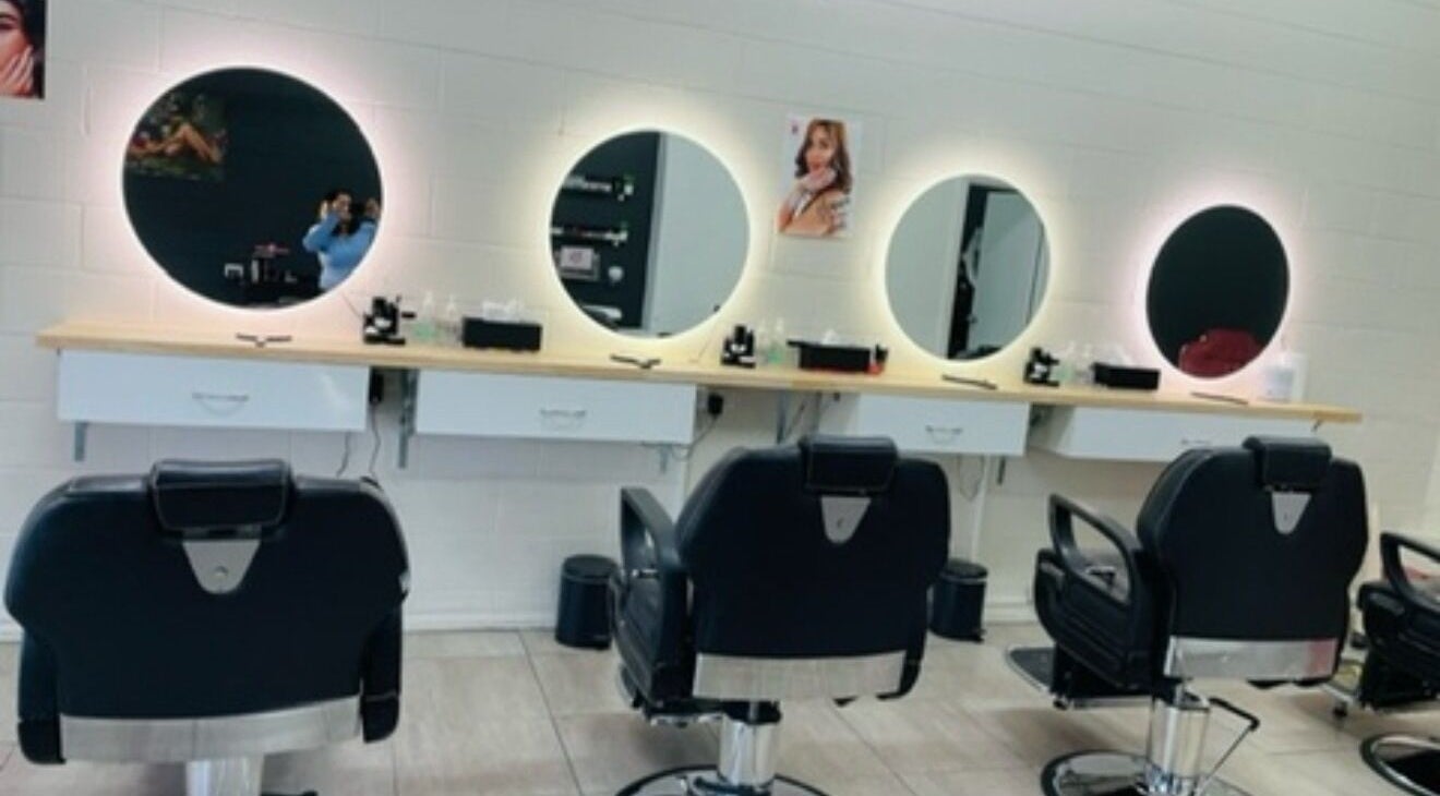 Elegant beauty stations at Brow Lash Beauty SA, Adelaide, South Australia, AU with illuminated mirrors and chairs.