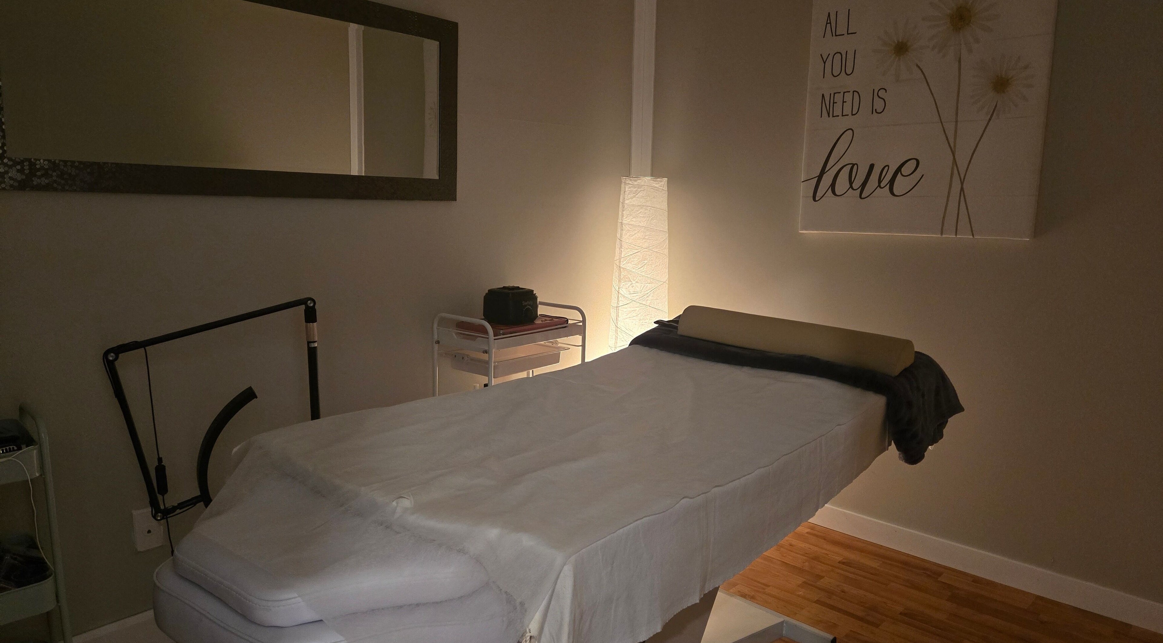 Relaxing massage room at Tree Treat Spa, Kawartha Lakes, Ontario, CA, featuring a cozy treatment bed and soft lighting.