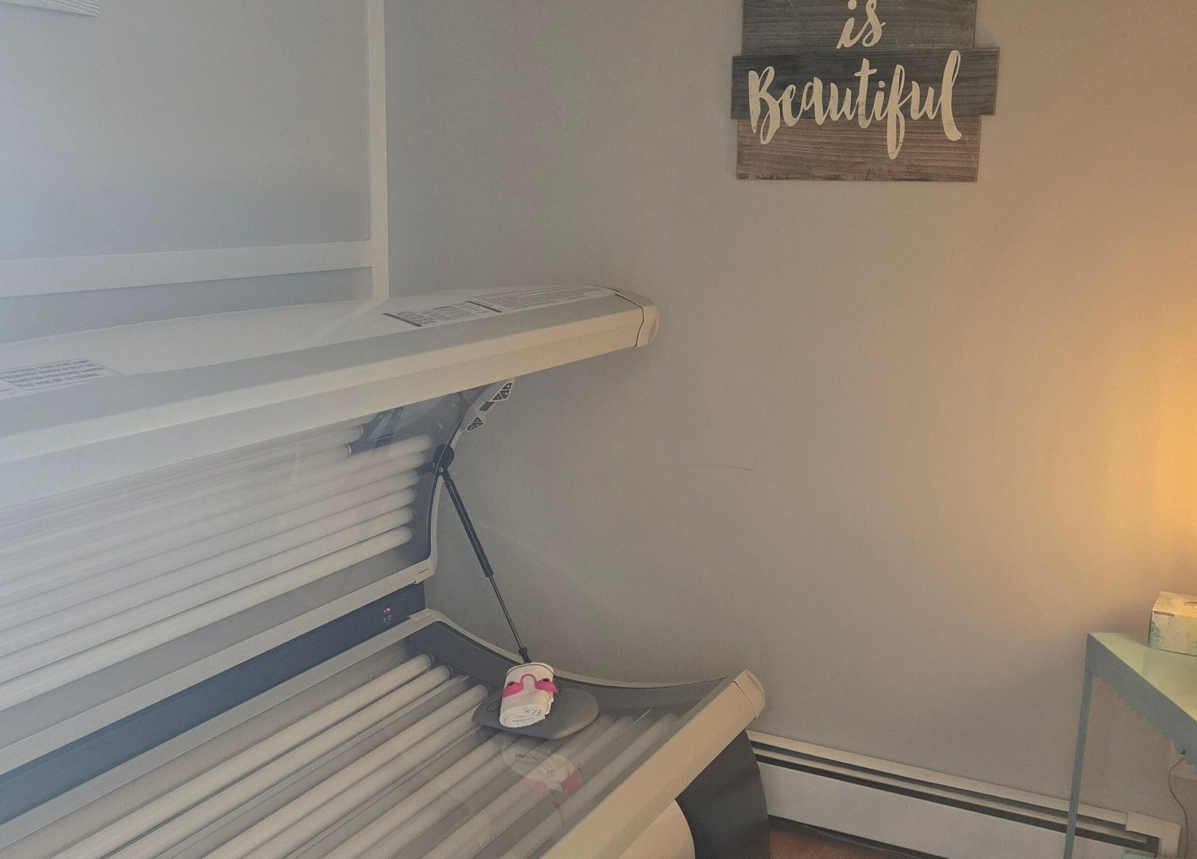 Relaxing tanning room at Tree Treat Spa, Kawartha Lakes, Ontario, CA with cozy lighting and modern sunbed.