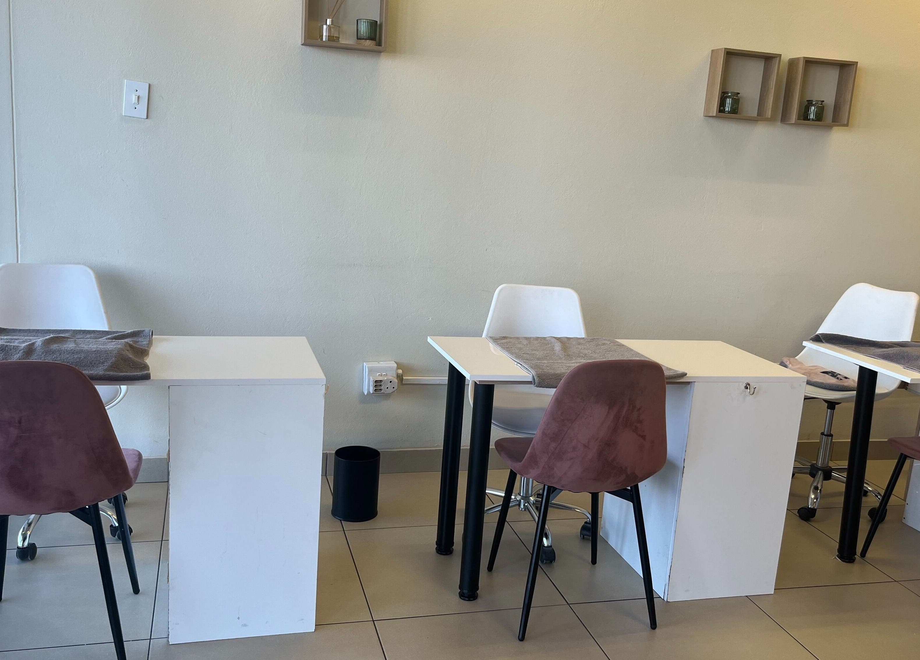 Chic nail salon setup at SBL Aesthetics & Beauty, Vanderbijlpark, Gauteng, ZA, featuring modern tables and chairs.