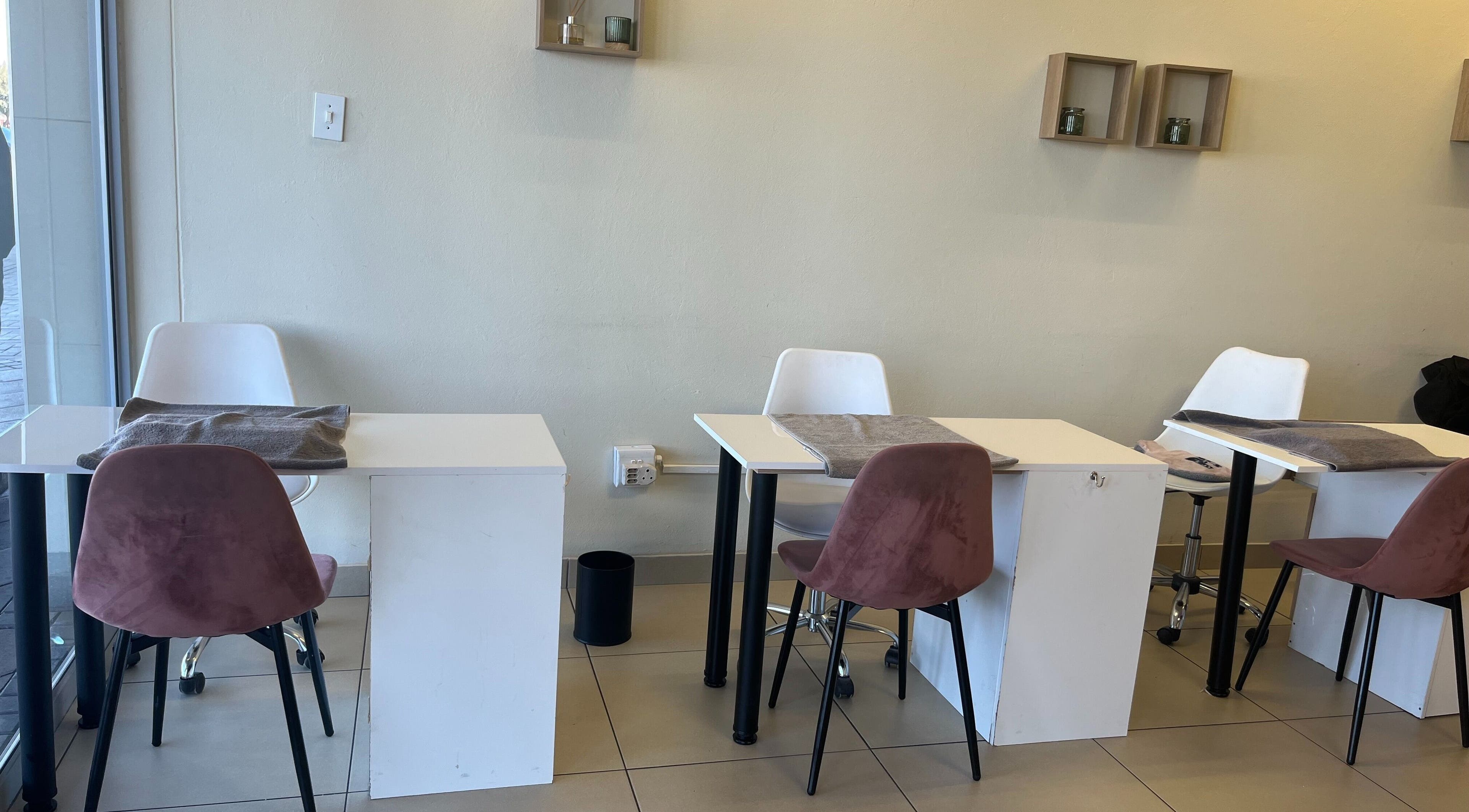 Chic nail salon setup at SBL Aesthetics & Beauty, Vanderbijlpark, Gauteng, ZA, featuring modern tables and chairs.