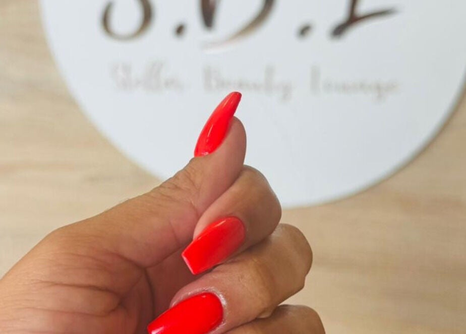 Bright red manicured nails at SBL Aesthetics & Beauty, Vanderbijlpark, Gauteng, ZA.