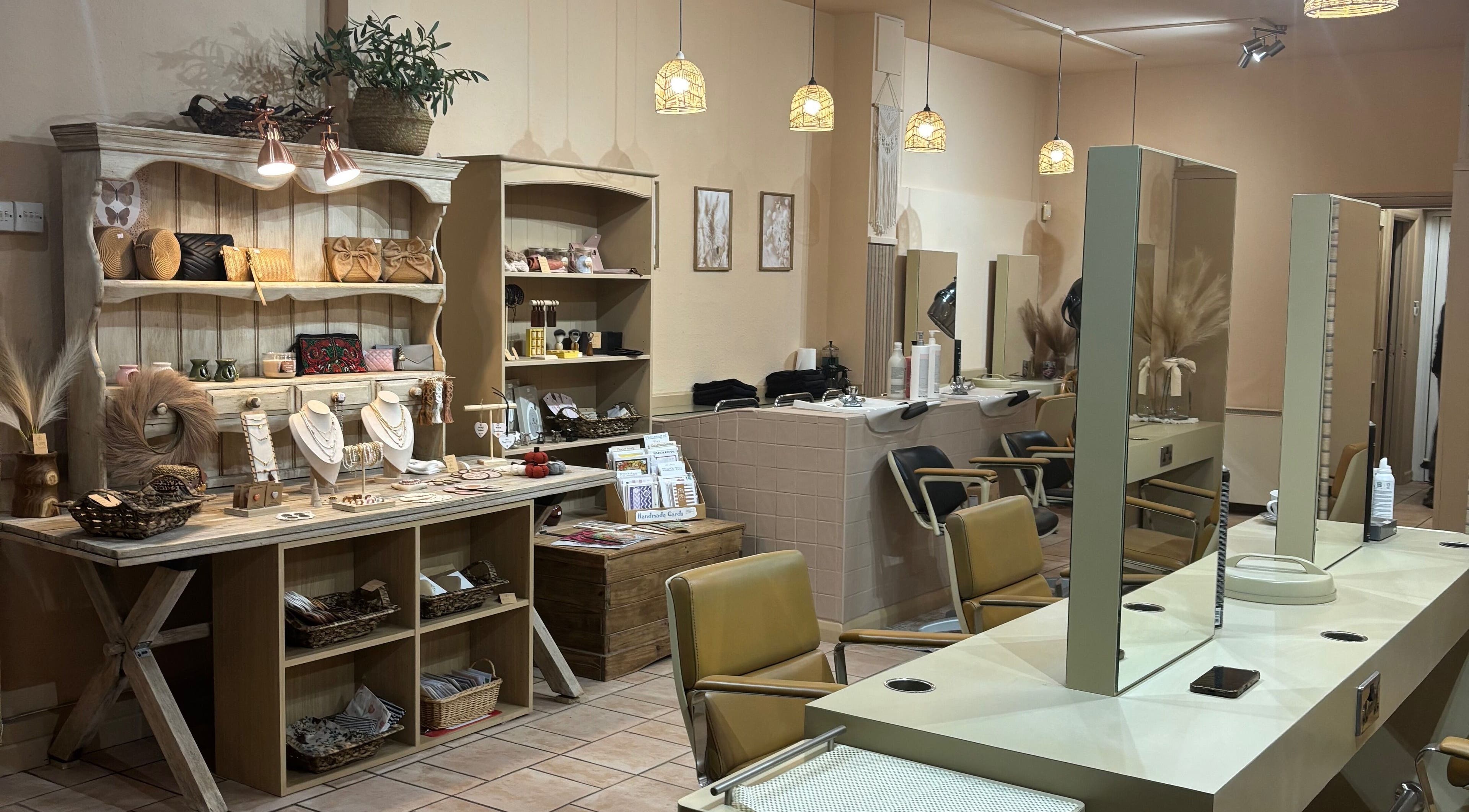 Elegant interior of Minnie's: Style Collective, Stoney Stanton, England, GB showcasing salon chairs and boutique items.