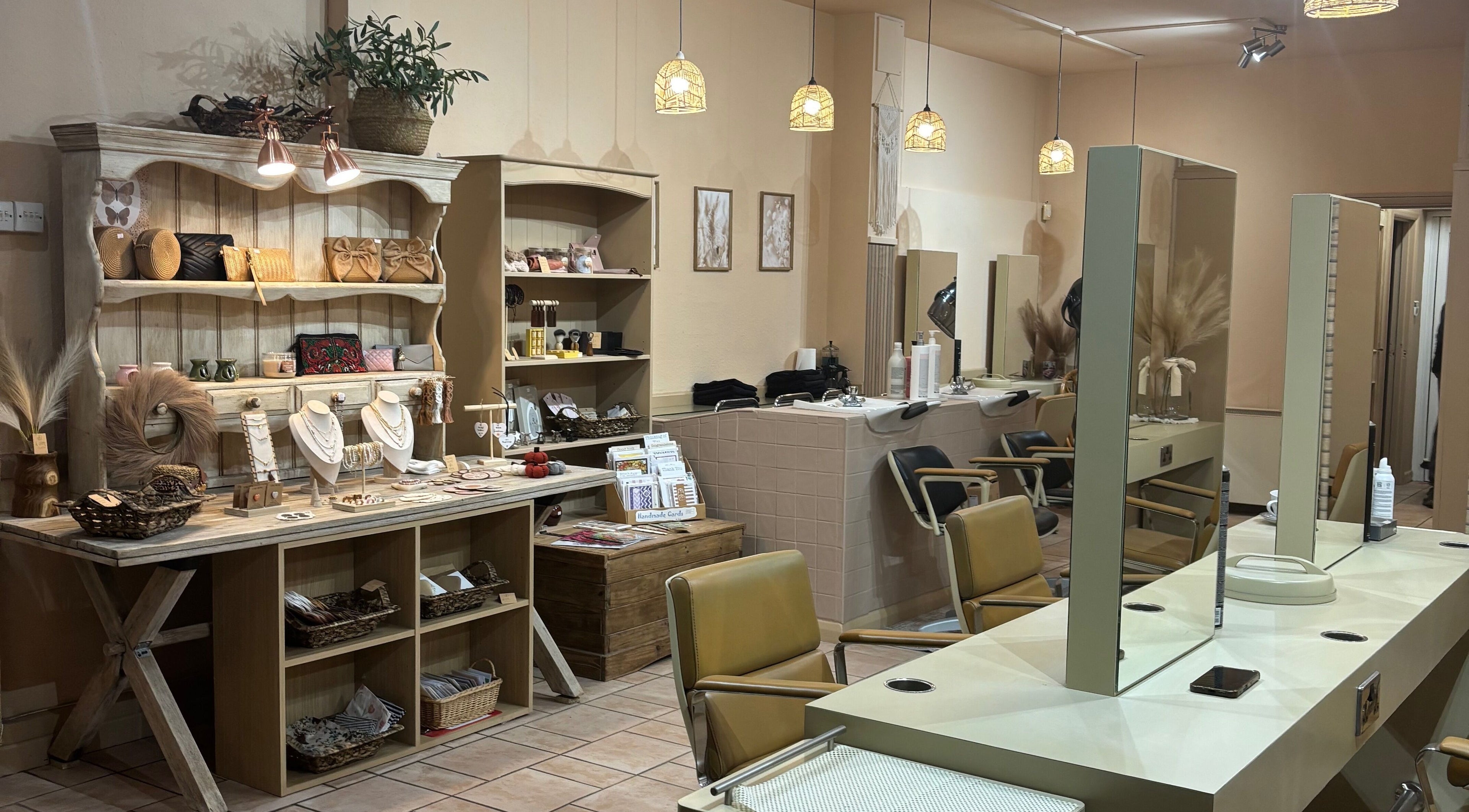 Elegant interior of Minnie's: Style Collective, Stoney Stanton, England, GB showcasing salon chairs and boutique items.