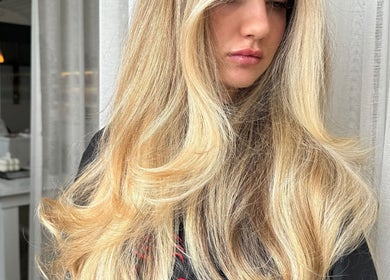 Blonde hair styled at Rinsd Hair, Palm Beach, Queensland, AU. Sleek salon interior visible.