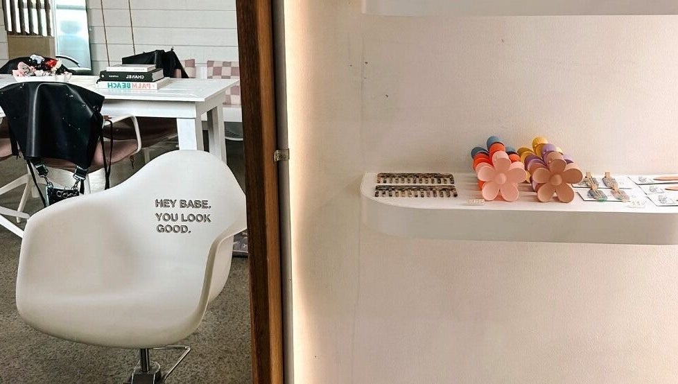 Modern salon chair and chic decor at Rinsd Hair in Palm Beach, Queensland, AU, showcasing inviting ambiance.