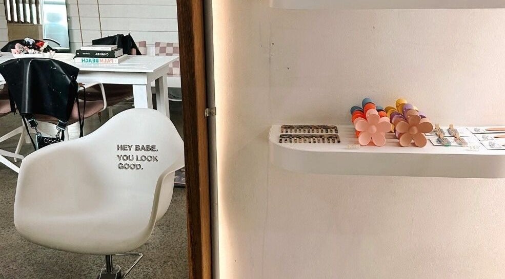 Modern salon chair and chic decor at Rinsd Hair in Palm Beach, Queensland, AU, showcasing inviting ambiance.