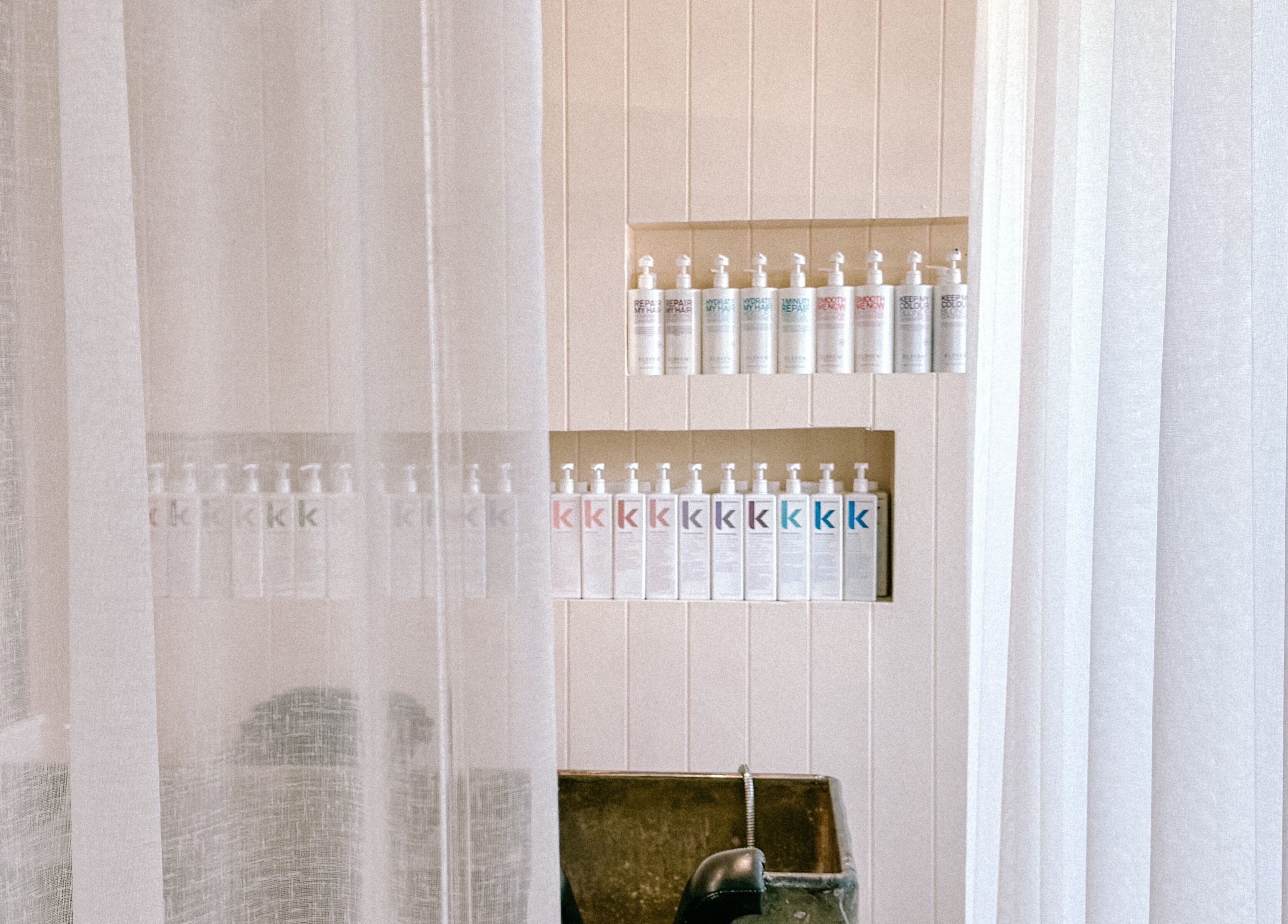 Serene shelves with hair products at Rinsd Hair, Palm Beach, Queensland, AU.