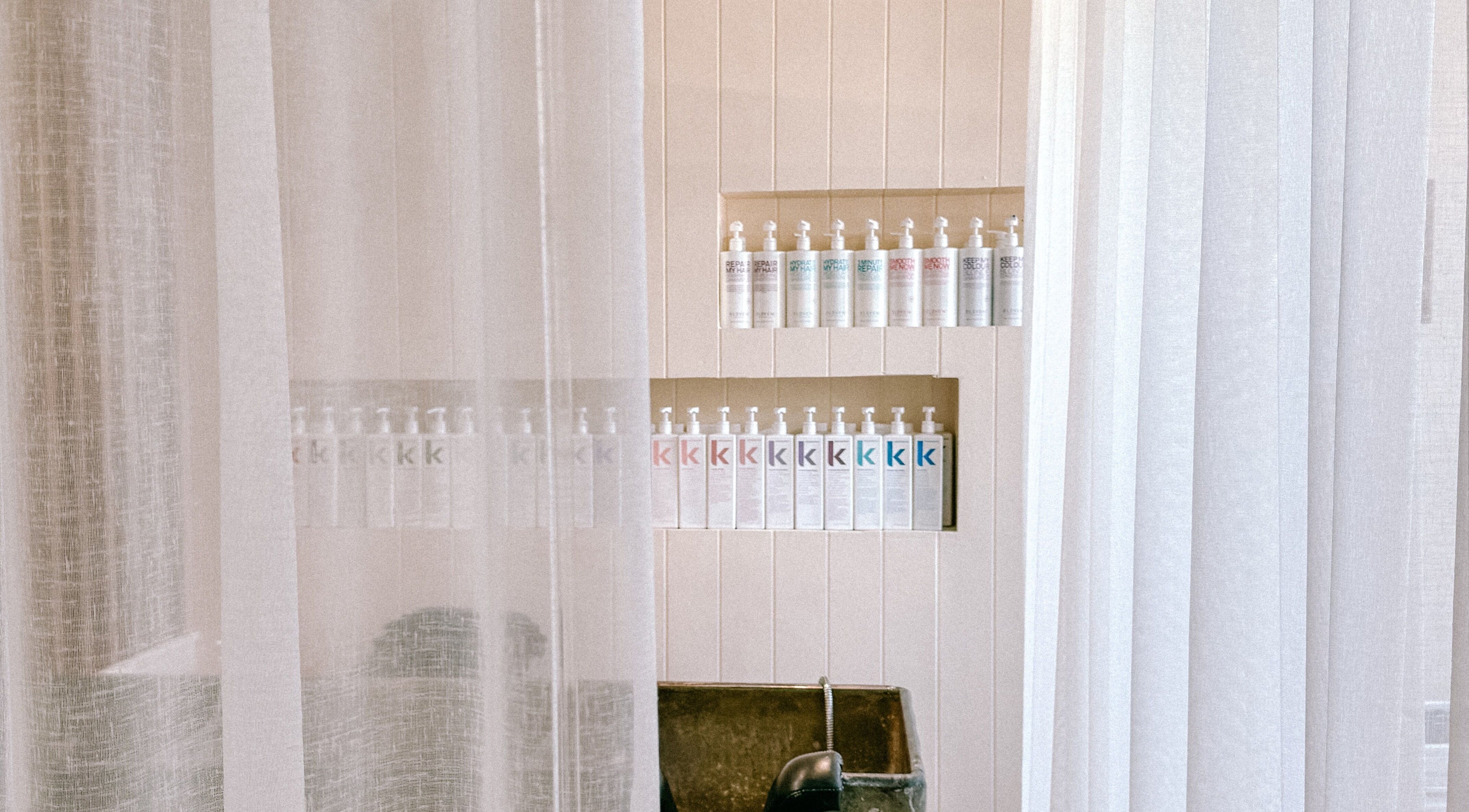 Serene shelves with hair products at Rinsd Hair, Palm Beach, Queensland, AU.