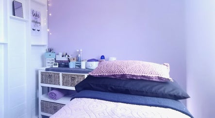 Relaxing treatment room at Nova Bella Beauty, Cape Town, Western Cape, ZA, with soft purple hues and cozy atmosphere.