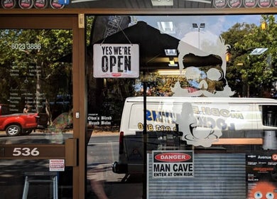 The Barbers Bru storefront in Albury, New South Wales, AU with open sign and bold window graphics.