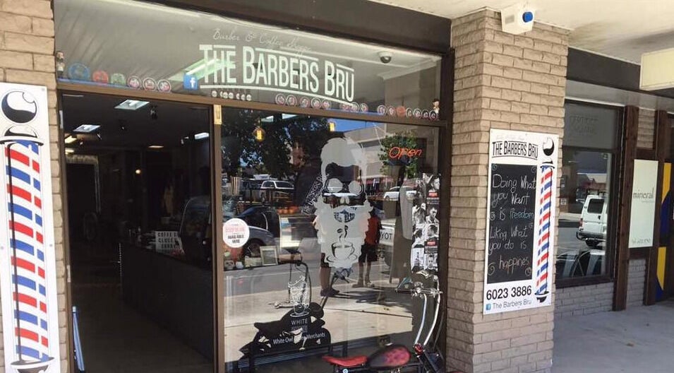 Entrance of The Barbers Bru in Albury, New South Wales, AU, featuring a classic barber pole sign.