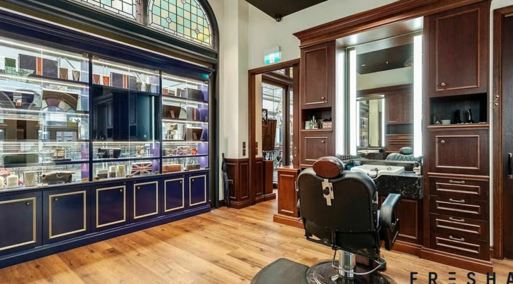 Refined barbershop interior at Truefitt and Hill - QVB, Sydney, New South Wales, AU with classic wooden decor.