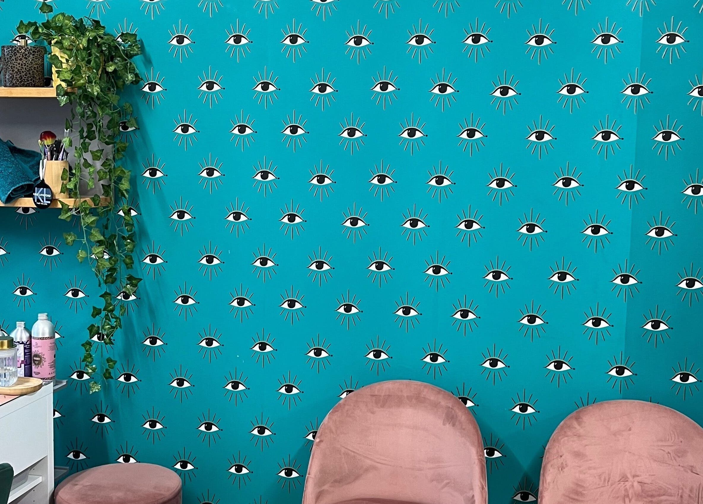 Trendy wall with eye pattern and cozy seating at Trim in Stafford, England, GB. Modern and inviting decor.