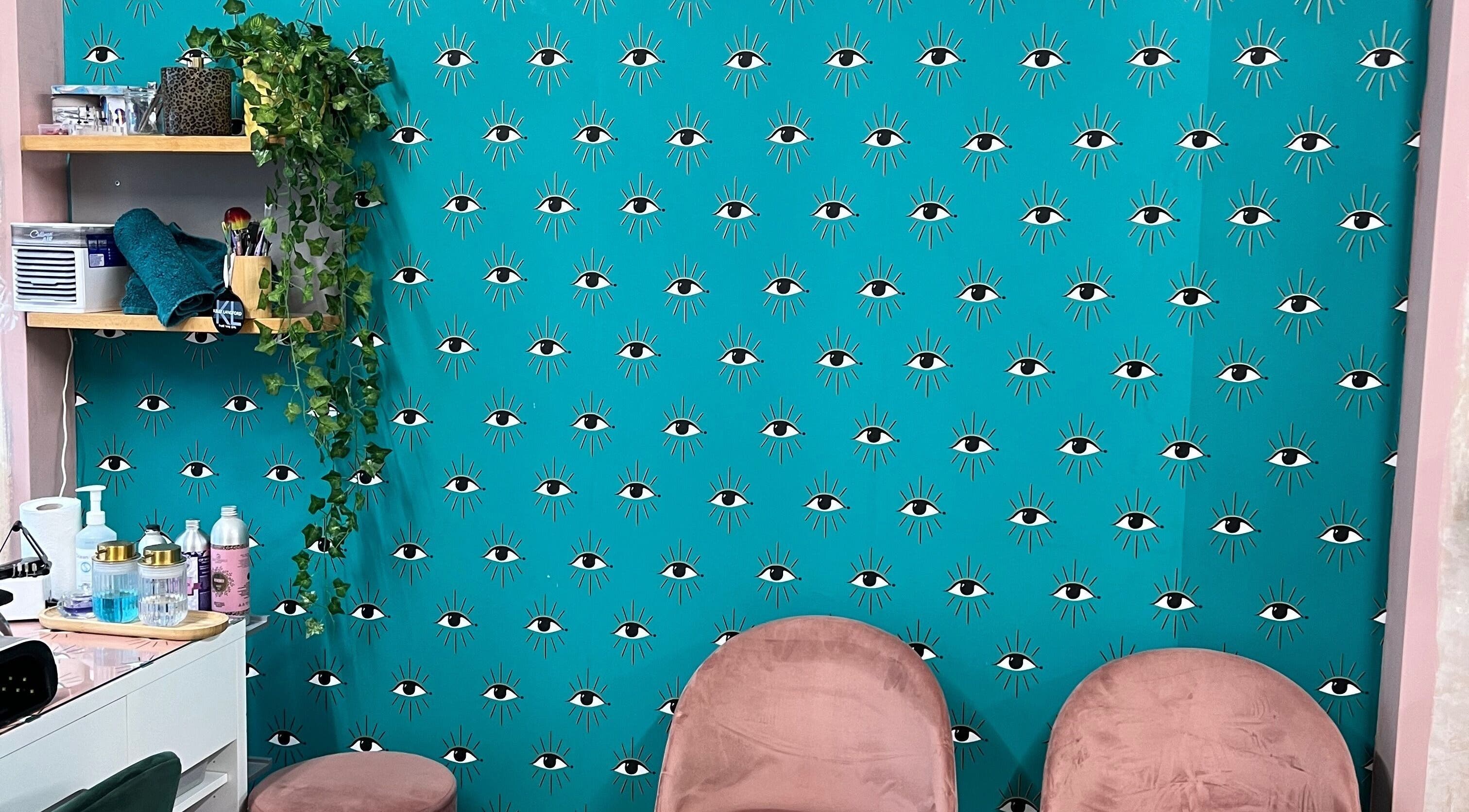 Trendy wall with eye pattern and cozy seating at Trim in Stafford, England, GB. Modern and inviting decor.