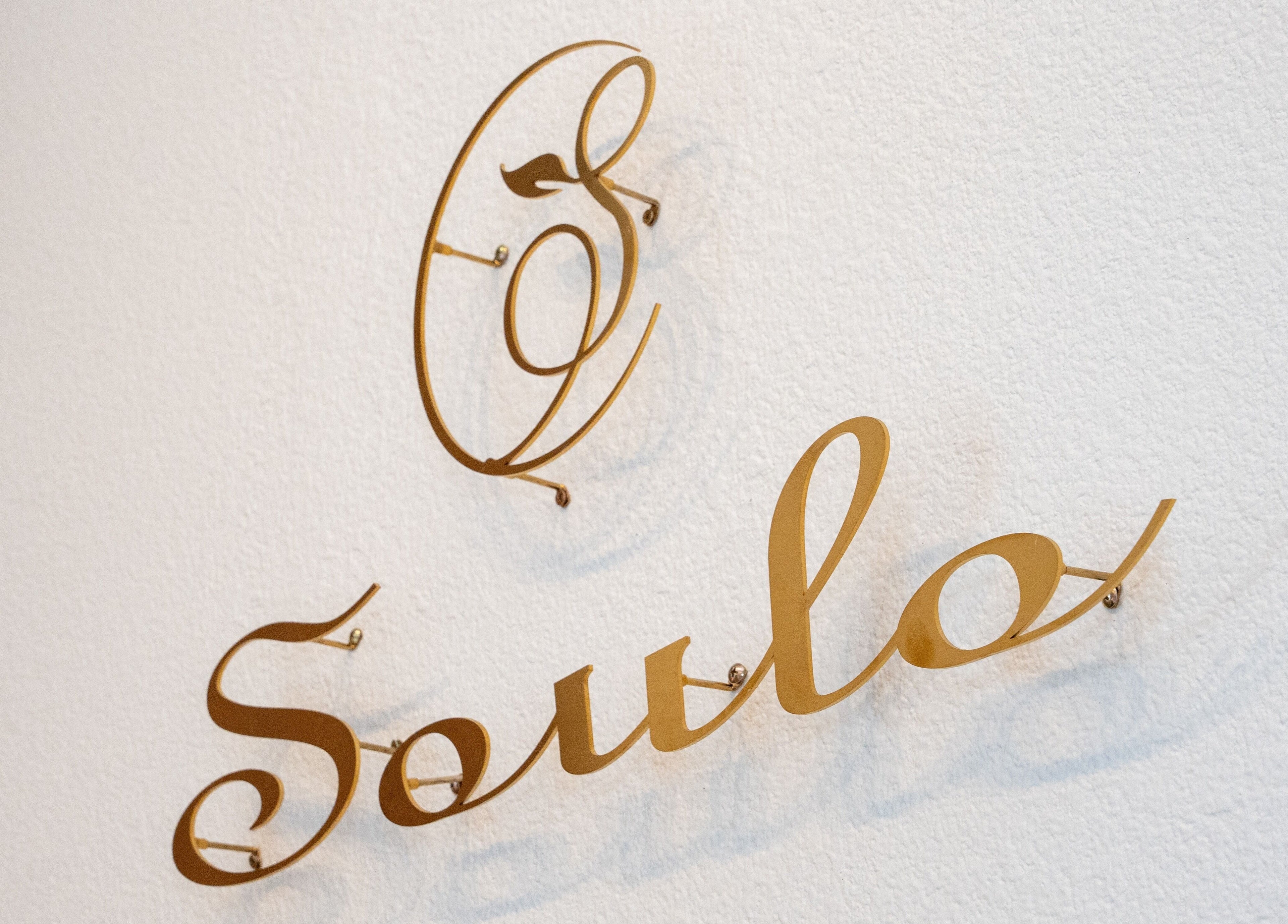 Elegant gold sign spelling 'Soulo' at Soulo Hair Spa Southwest, Las Vegas, Nevada, US.