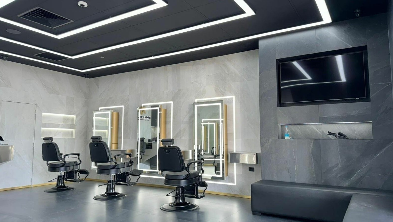 Modern interior of Royal Blends - Gregory Hills, Gledswood Hills, New South Wales, AU with stylish barber chairs.